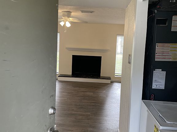 Entry: laundry right, kitchen to left. Living room forward with wood burning fireplace.