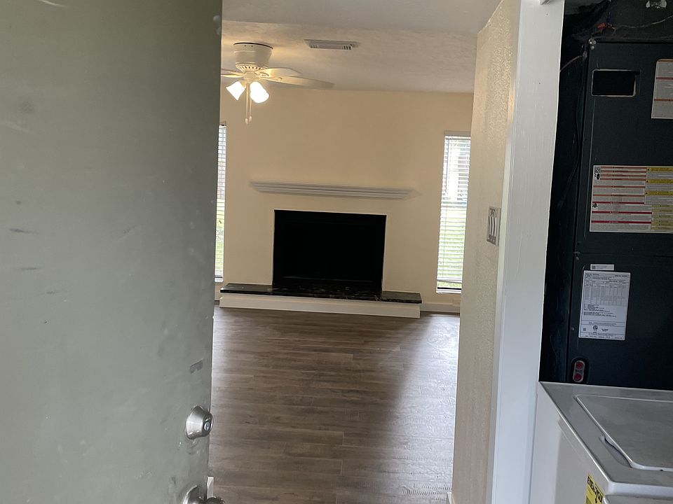 Entry: laundry right, kitchen to left. Living room forward with wood burning fireplace.
