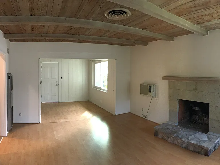 View of fireplace, living room, and dining room