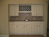 Wet bar features granite counters, wine rack with light and lots of cabinets
