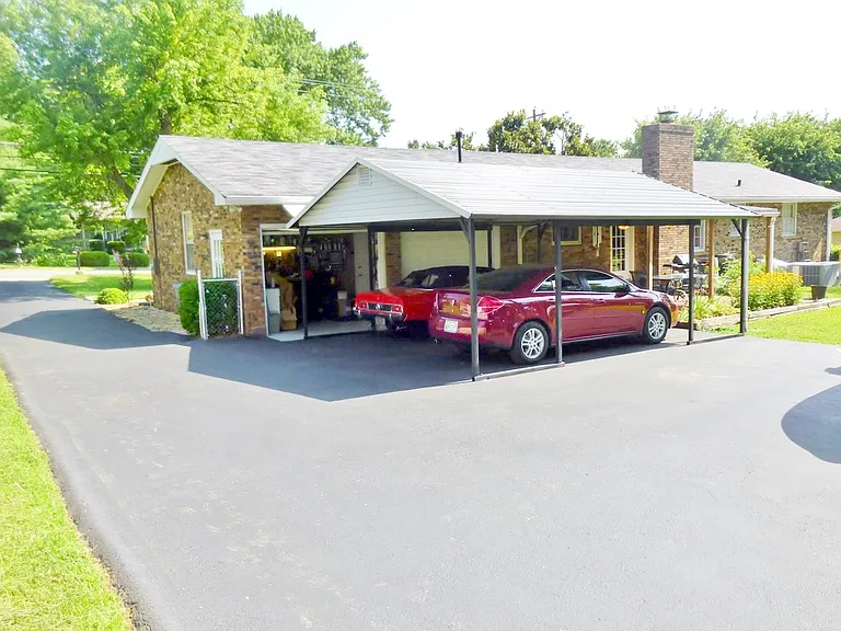 2 car carport. 4parking places in all.
Small workshop in this picture.
