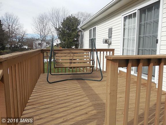 Nice deck with swing overlooks back yard.