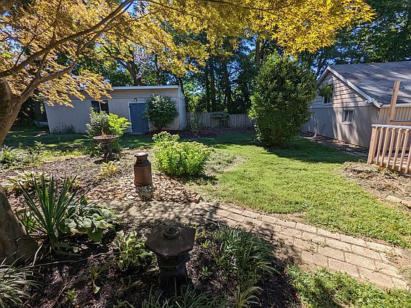 Backyard, storage garage on left, detached 2 car garage on right