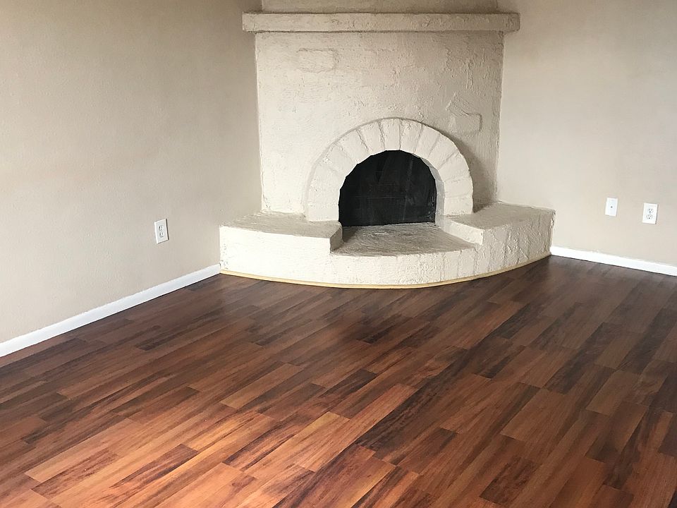 Living room with beehive fireplace and hardwood floors