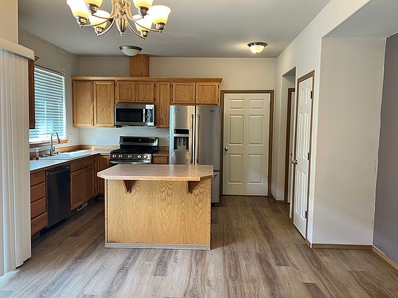 Open kitchen first floor. Door straight ahead accesses the attached garage. Doors on the right wall are to a closet, a half bath, and a pantry.