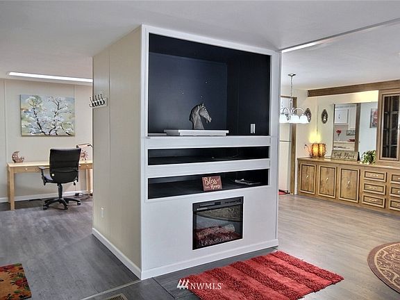 You'll also notice the custom built-in entertainment center with electric fireplace. This picture is looking towards the entry/office space on the left and the formal dining room on the right. Cable is hardwired to the entertainment center, the office space and the 2nd bedroom.