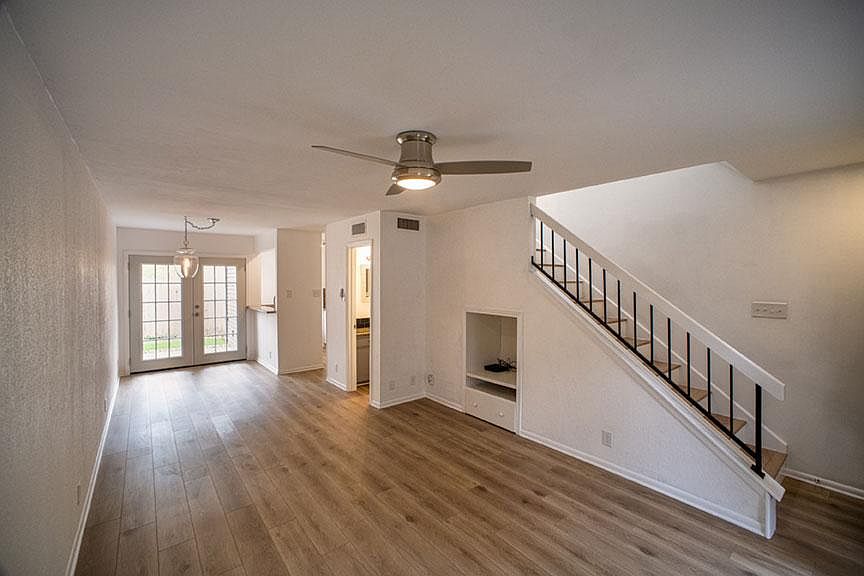 Open living and dining areas leading to privately, fenced-in backyard.