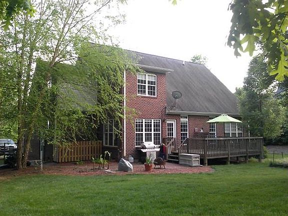 Back of Home w/ Deck & Patio