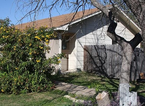 View of corner of the unit with sidewalk leading to the unit