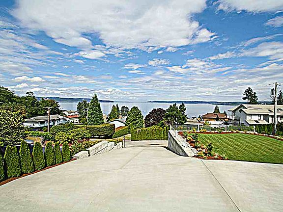 Enjoy your new 600 sq. ft. deck. It wraps all the way around the front of the home with French doors leading into the kitchen.