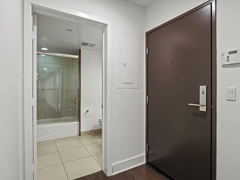 Front Door Entrance with Alarm System and a Full-Size Hall Bathroom