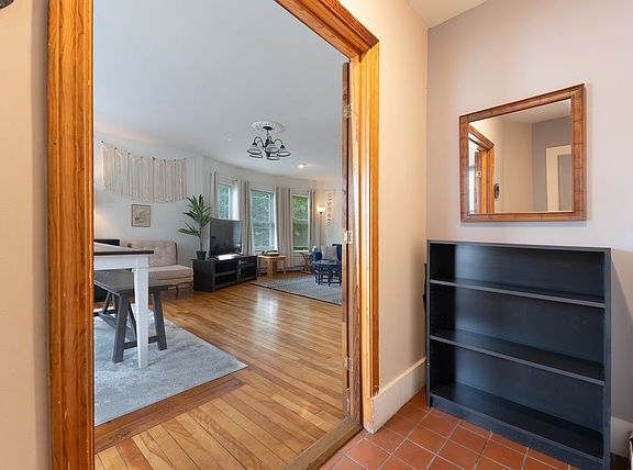 The entryway, with an area for shoes/coats. Entry to basement is here, which has the laundry area (that is only for this unit).