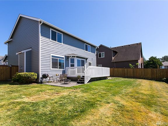 Fully fenced back yard with newly painted deck and patio for entertaining!