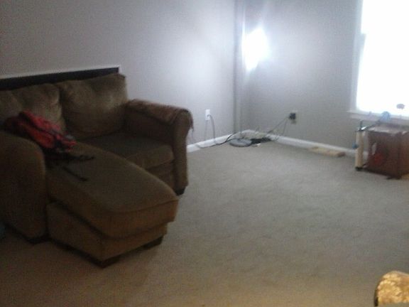 Angle of living room, loveseat hiding sofa