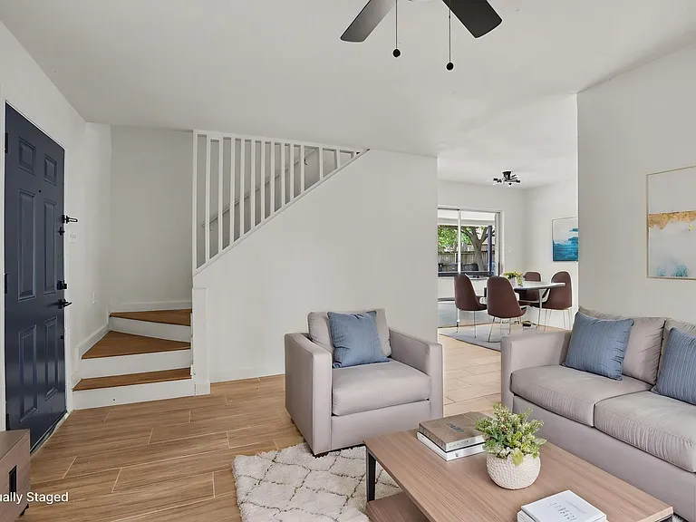 Downstairs living area. Virtually staged - unit does not come furnished.