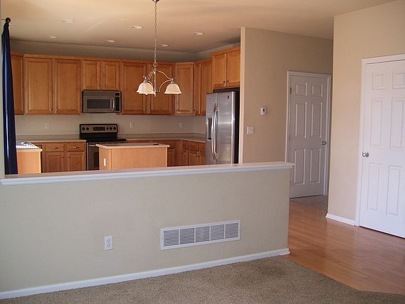 Kitchen, custom cabinetry, wood flooring, upgraded appliance