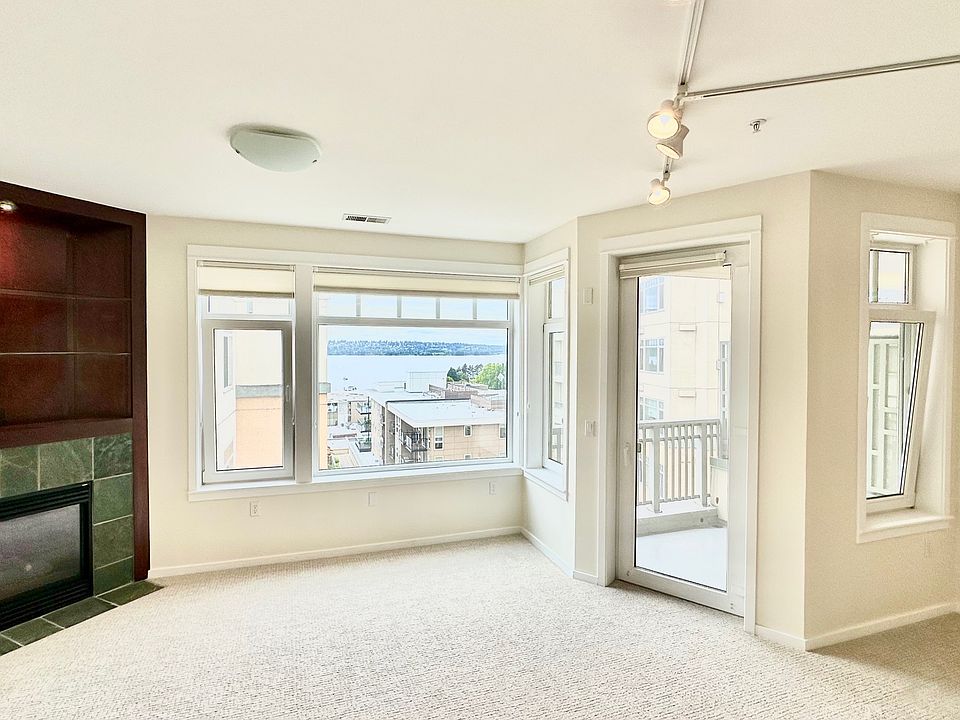 Living room with lake view and gas fireplace.