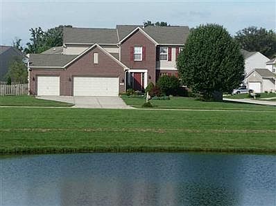 Exterior Front. The view  is incredible out of your front windows! Large corner lot is a bonus and premium lot on the pond and corner.