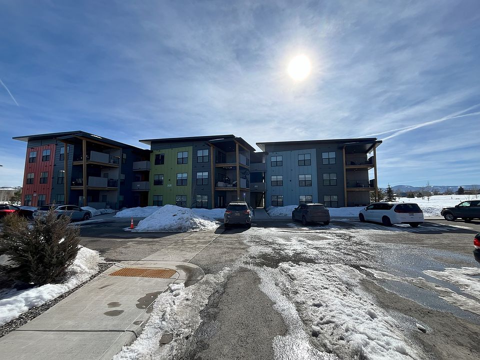 Exterior view from parking; unit faces city park (other side of building). Access is through breezeway to other side.