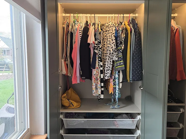 "His and Her" closet and drawers with pull out shoe racks and storage above.