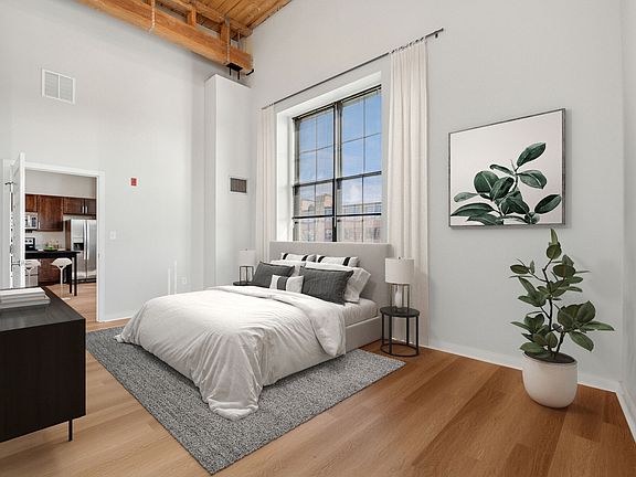 Bright loft-style bedroom with large windows and modern industrial design