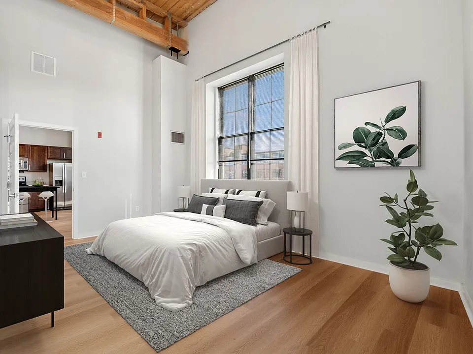 Bright loft-style bedroom with large windows and modern industrial design