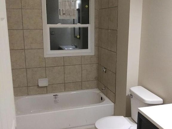 Completely new bathroom installed during rehab! Everything new from tub, ceramic tile tub surround, vanity and vanity top, mirror, light, and even the trim and door!