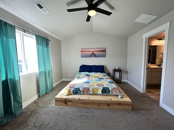 Master bedroom with master bathroom and walk-in closet