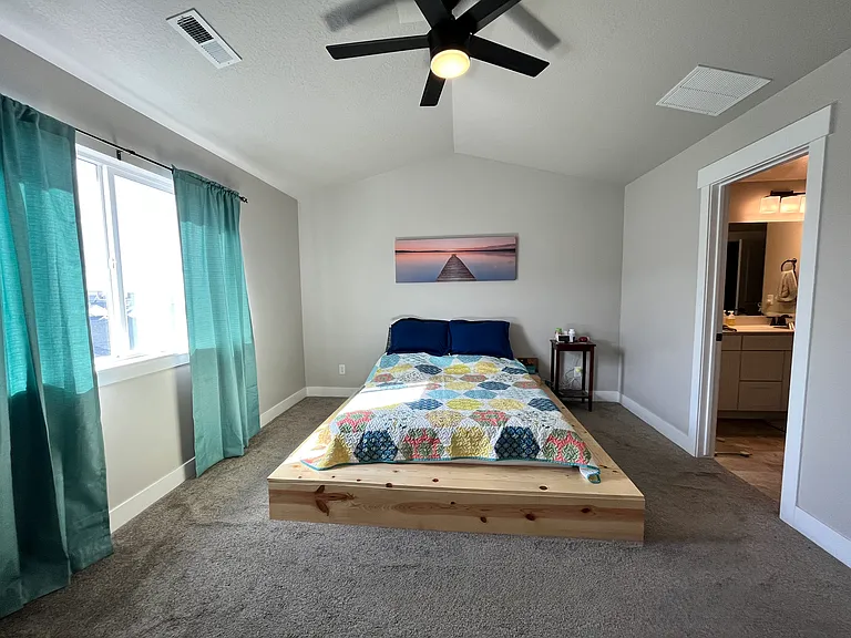 Master bedroom with master bathroom and walk-in closet