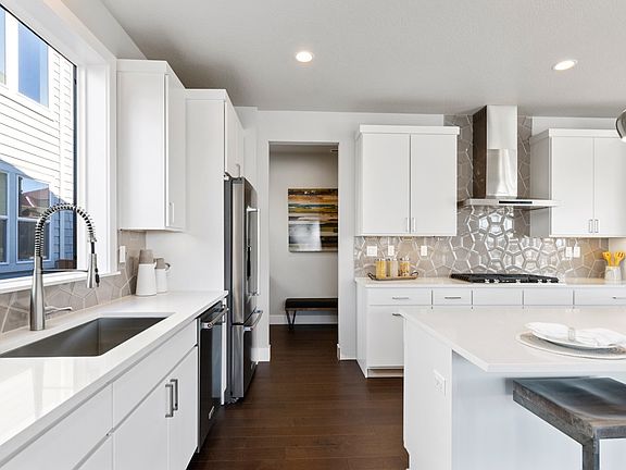 Well designed kitchen with drop zone walk-in pantry behind