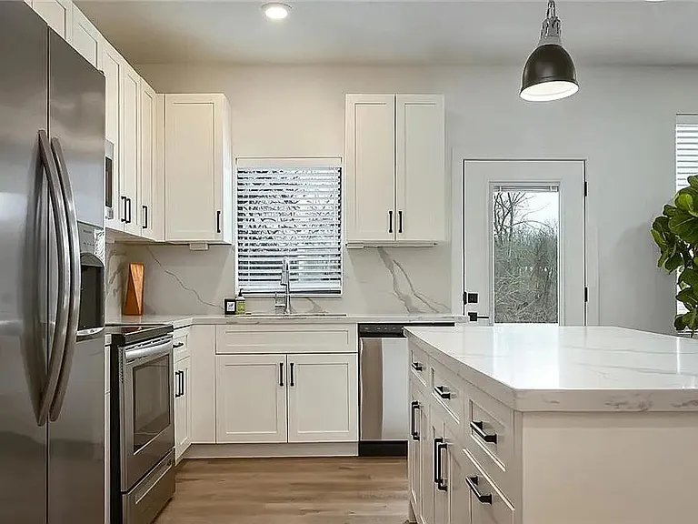 Modern kitchen featuring quartz-style countertops, stainless steel appliances, custom cabinetry, and open-concept design.

Photos are representative and finishes or layouts may vary slightly by unit.