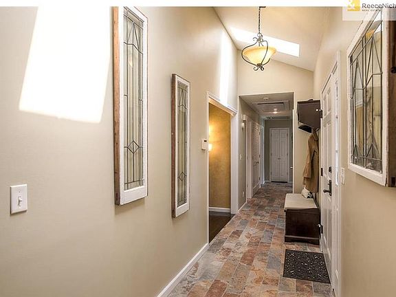 Bright and Cheery Entry with Beautiful Slate Tile and Skylight.