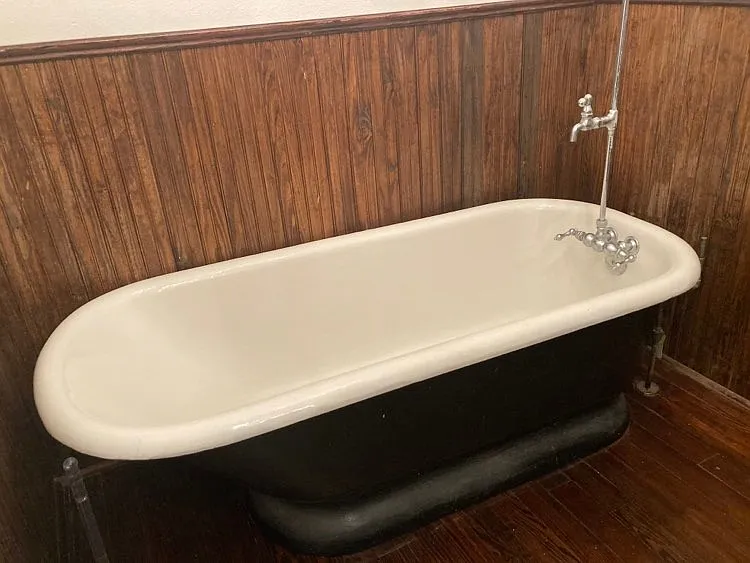 BATHROOM CLAWFOOT TUB WITH BEADBOARD ON WALLS