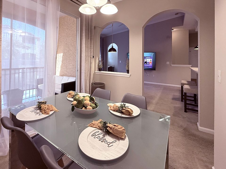 Glass dining room with four chairs.
