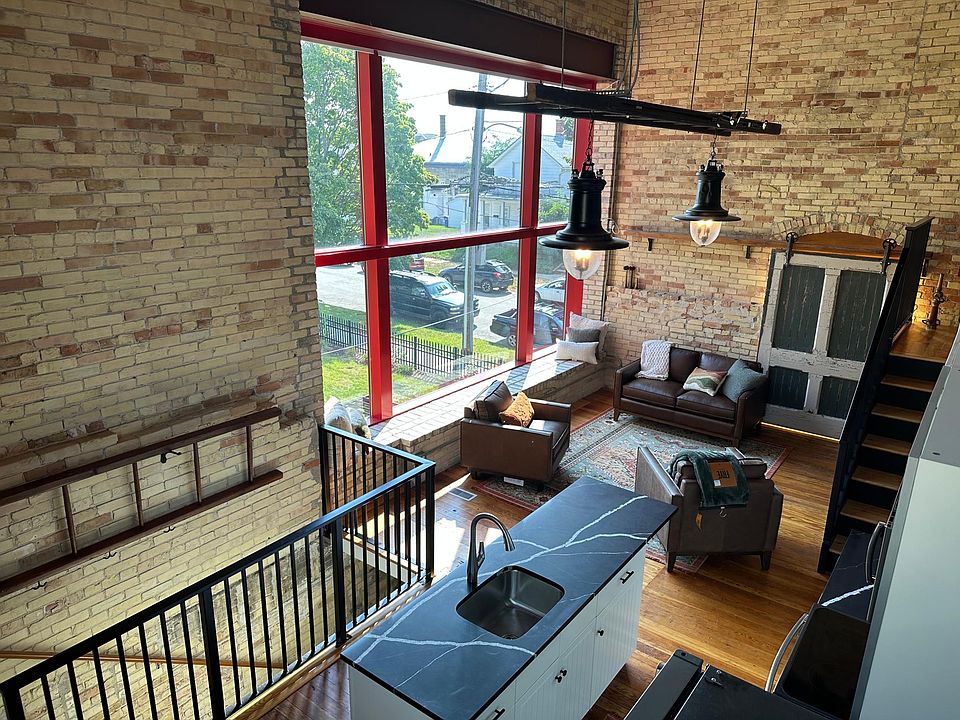 Loft living area with powered window shades