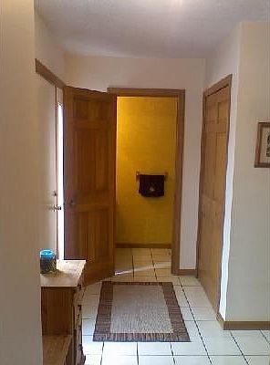 Beautiful ceramic tile entry with powder room and hall closet.