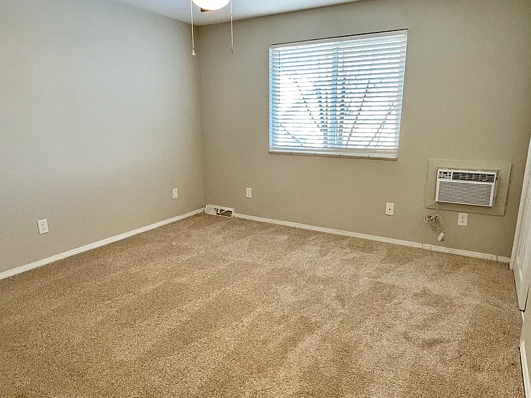 Enjoy a bright and airy bedroom featuring a modern ceiling fan and plush carpet. Enjoy a bright and airy bedroom featuring a modern ceiling fan and plush carpet.