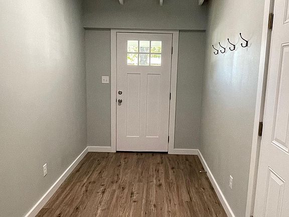 Entrance hall with exposed original ceilings and vintage iron hooks to hang all of the important stuff.