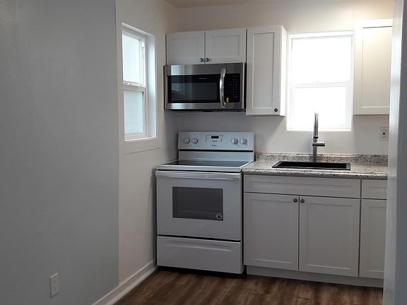 Glass top electric range and stainless steel microwave oven