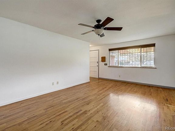 Bright and spacious living room; refurbished hardwood floors!.