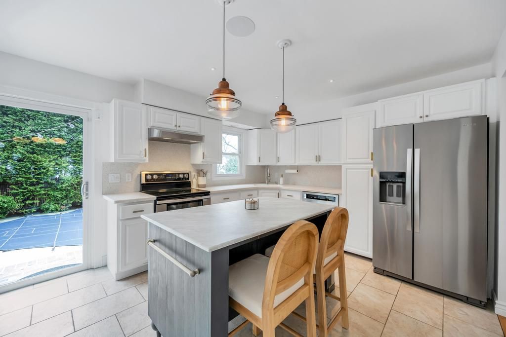  Spacious eat in kitchen with center island, stainless steel appliances.