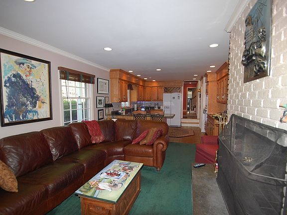 Family Room - Carpet over hardwood floor, brick fireplace
