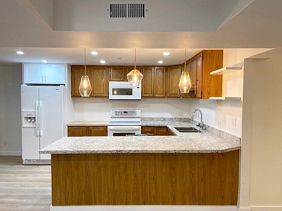 Full kitchen with microwave, range/oven, refrigerator and dishwasher