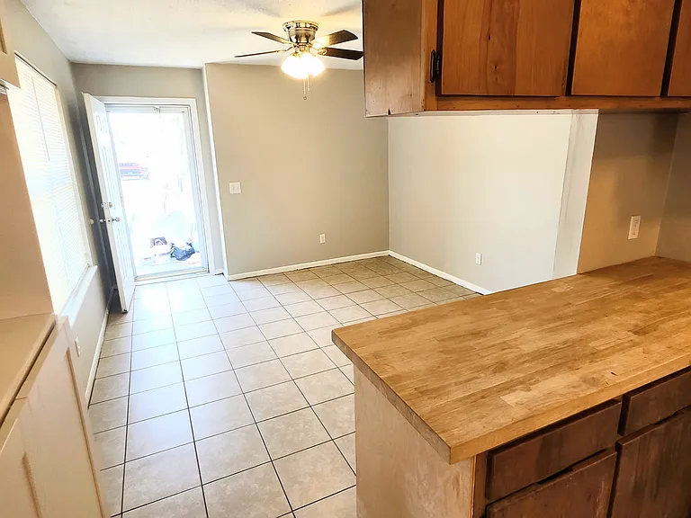 View from kitchen of glass front door and living room