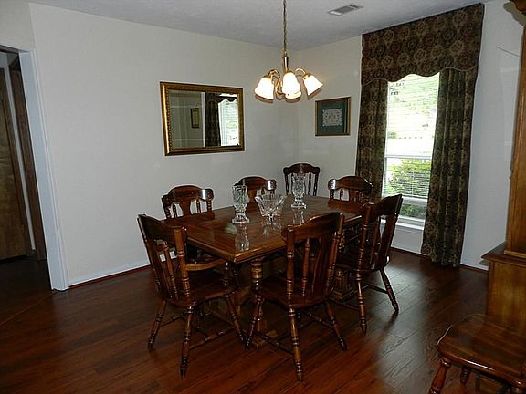 Elegant Formal Dining Room offer Rich Wood Floors