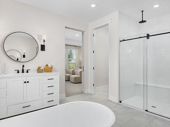 Primary bath with glass shower enclosure and freestanding tub