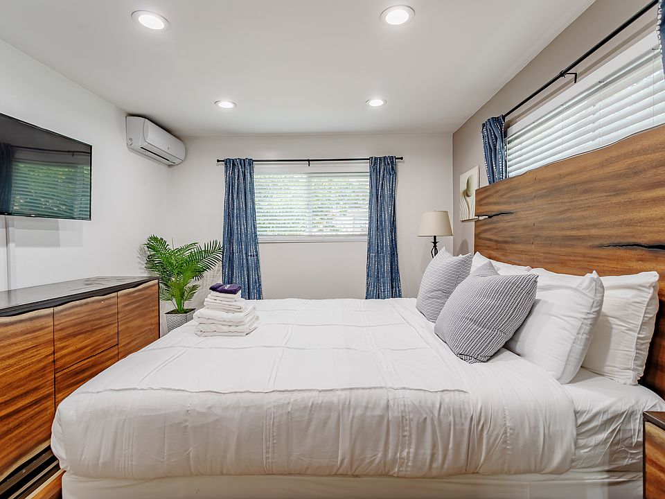 Main Bedroom of the home with wood accents. You have a Cal King Bed and Roku Smart TV.