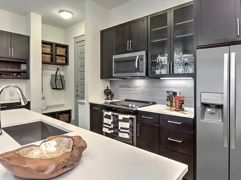 Kitchens are complete with stainless steel appliances.