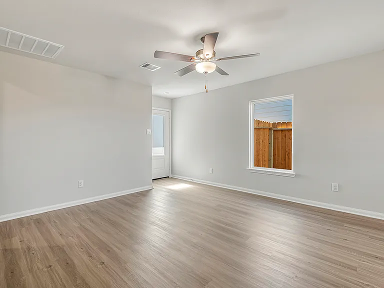 A spacious family room with ceiling fan.