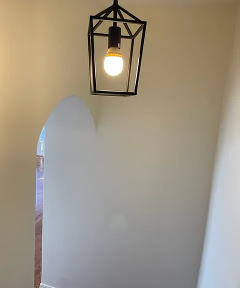 203 Formal entry hall leads to arched door to main room